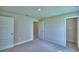 Bedroom featuring carpeted floor, base molding, and doors to a walk-in closet at 4688 Grandview Glen Dr, Auburndale, FL 33823