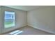 Bedroom showcasing base molding, a window, and a neutral color scheme at 4688 Grandview Glen Dr, Auburndale, FL 33823