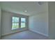 Bedroom with two windows, carpet flooring, and neutral walls at 4688 Grandview Glen Dr, Auburndale, FL 33823
