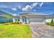 Charming single-story home with a tile roof, paver driveway, and well-manicured landscaping at 4688 Grandview Glen Dr, Auburndale, FL 33823