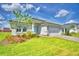 Beautiful single-story home featuring a well-maintained lawn and a light blue front door at 4688 Grandview Glen Dr, Auburndale, FL 33823