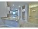 Open kitchen with a breakfast bar, white cabinetry, and stainless steel appliances at 4688 Grandview Glen Dr, Auburndale, FL 33823