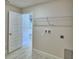 Spacious laundry room with tile floors, washer/dryer hookups, and wire shelf at 4688 Grandview Glen Dr, Auburndale, FL 33823