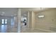 Open floorplan with tile floors and a kitchen with white cabinets and stainless steel appliances at 4688 Grandview Glen Dr, Auburndale, FL 33823