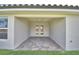 An outdoor covered patio with a brick floor and double doors leading inside at 4688 Grandview Glen Dr, Auburndale, FL 33823