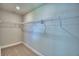 Walk-in closet with a tan carpet and metal shelving at 4688 Grandview Glen Dr, Auburndale, FL 33823