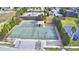 Aerial view showcases a tennis and basketball court, pool, and clubhouse with lush landscaping at 4694 Grandview Glen Dr, Auburndale, FL 33823