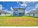 Expansive backyard with lush green grass and view of the home's back exterior at 4694 Grandview Glen Dr, Auburndale, FL 33823