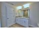 Bright bathroom featuring a double sink vanity with granite countertop and modern lighting at 4694 Grandview Glen Dr, Auburndale, FL 33823