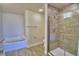 Modern bathroom with glass shower, bathtub, and gray tile; new and inviting at 4694 Grandview Glen Dr, Auburndale, FL 33823