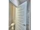 A half bath with a white toilet and a view of the door to the hallway at 4694 Grandview Glen Dr, Auburndale, FL 33823