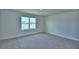 Bedroom with neutral carpet, white trim, a window, and neutral walls at 4694 Grandview Glen Dr, Auburndale, FL 33823