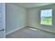 Bright bedroom featuring a window overlooking neighborhood at 4694 Grandview Glen Dr, Auburndale, FL 33823