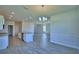 Open concept dining area with modern chandelier, and tile flooring at 4694 Grandview Glen Dr, Auburndale, FL 33823