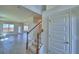 Foyer view with staircase, light tile flooring, and an entry to the living area at 4694 Grandview Glen Dr, Auburndale, FL 33823