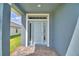 Inviting front door with sidelights and transom window, set in a stylish entryway at 4694 Grandview Glen Dr, Auburndale, FL 33823