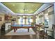Bright game room featuring a pool table, seating area, and natural light from large windows at 4694 Grandview Glen Dr, Auburndale, FL 33823