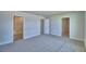 Hallway with access to bathroom, closet, and bedroom; neutral walls and carpet at 4694 Grandview Glen Dr, Auburndale, FL 33823