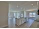 Open-concept kitchen with island, stainless appliances, and tile floors at 4694 Grandview Glen Dr, Auburndale, FL 33823
