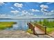 Scenic lake view showcasing a wooden dock and boat ramp, perfect for enjoying waterfront activities at 4694 Grandview Glen Dr, Auburndale, FL 33823