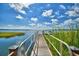Scenic lake view showcasing a wooden dock and boat ramp, perfect for enjoying waterfront activities at 4694 Grandview Glen Dr, Auburndale, FL 33823