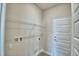 Clean laundry room with wire shelving, white door, and available hookups at 4694 Grandview Glen Dr, Auburndale, FL 33823