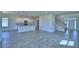 Open living area with staircase, white cabinets, and tile flooring at 4694 Grandview Glen Dr, Auburndale, FL 33823