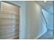 Spacious pantry with metal shelving near the staircase and hallway at 4694 Grandview Glen Dr, Auburndale, FL 33823