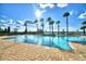 Community pool with palm trees and lounge chairs overlooking the water at 4694 Grandview Glen Dr, Auburndale, FL 33823