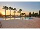 Community pool with palm trees and lounge chairs in the evening at 4694 Grandview Glen Dr, Auburndale, FL 33823