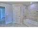 Bathroom showcases a tiled shower and separate soaking tub, along with tile floors, and doorway at 4700 Grandview Glen Dr, Auburndale, FL 33823
