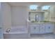 Bathroom featuring tub, and double vanity at 4700 Grandview Glen Dr, Auburndale, FL 33823
