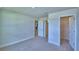 Bright bedroom features plush carpet, closet, and doorways leading to other rooms in the home at 4700 Grandview Glen Dr, Auburndale, FL 33823