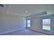 Spacious bedroom featuring tray ceiling and two large windows at 4700 Grandview Glen Dr, Auburndale, FL 33823
