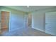 Neutral bedroom includes a closet and doorways to other rooms, neutral carpet and paint, and base trim at 4700 Grandview Glen Dr, Auburndale, FL 33823