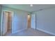 Bedroom features neutral carpet, closet, doorways leading to other rooms, neutral walls, and base trim at 4700 Grandview Glen Dr, Auburndale, FL 33823
