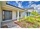 Inviting front entrance with a brick walkway, fresh landscaping, and covered porch at 4700 Grandview Glen Dr, Auburndale, FL 33823