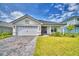 Charming single-story home with a two-car garage, lush lawn, and inviting front entrance at 4700 Grandview Glen Dr, Auburndale, FL 33823