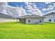 Expansive backyard featuring lush green grass, a modern patio, and a neutral-toned exterior of the single story home at 4706 Grandview Glen Dr, Auburndale, FL 33823