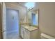 Light bathroom showcasing vanity with a large mirror and granite countertops at 4706 Grandview Glen Dr, Auburndale, FL 33823