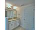 Modern bathroom featuring double sinks with granite countertops and a large mirror at 4706 Grandview Glen Dr, Auburndale, FL 33823
