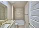 Bright bathroom featuring vanity with granite countertop, tile surround tub, and open doorway at 4706 Grandview Glen Dr, Auburndale, FL 33823