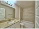 Well-lit bathroom showcasing vanity with granite countertops, plus tile surround tub at 4706 Grandview Glen Dr, Auburndale, FL 33823