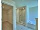 Beautiful ensuite bathroom with tiled walk-in shower and a soaking tub at 4706 Grandview Glen Dr, Auburndale, FL 33823