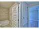 Contemporary bathroom featuring tile surround tub and built-in linen closet at 4706 Grandview Glen Dr, Auburndale, FL 33823