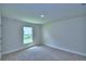 Neutral bedroom featuring a window, wall-to-wall carpet, and base molding at 4706 Grandview Glen Dr, Auburndale, FL 33823