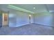 An airy bedroom features a tray ceiling and access to the ensuite bathroom at 4706 Grandview Glen Dr, Auburndale, FL 33823