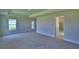 Bright bedroom features an ensuite bath, a large window, and neutral walls at 4706 Grandview Glen Dr, Auburndale, FL 33823