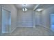 Open dining room with modern light fixture and decorative wainscoting at 4706 Grandview Glen Dr, Auburndale, FL 33823