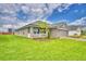 Well-maintained home with lush green lawn, showcasing the side view and landscaping at 4706 Grandview Glen Dr, Auburndale, FL 33823